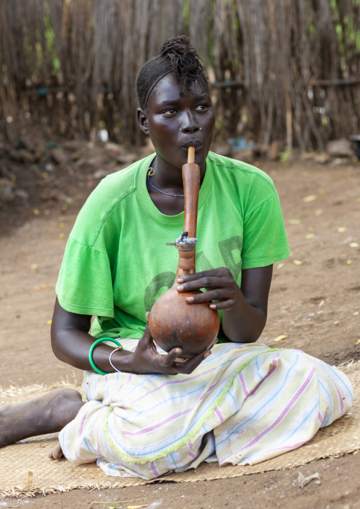 Anuak tribe woman smoking pipe, Dima, Gambela province, Ethiopia