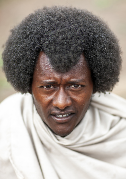 Portrait of a Karrayyu man with traditional hairstyle, Oromia, Metahara, Ethiopia