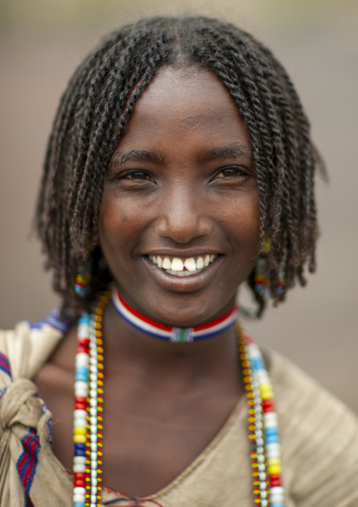 Portrait of a smiling Karrayyu young woman, Oromia, Metahara, Ethiopia