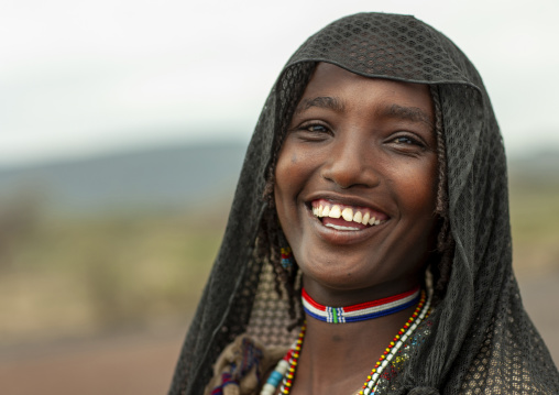Portrait of a smiling Karrayyu young woman, Oromia, Metahara, Ethiopia