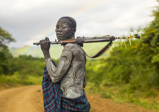 Portrait of a Surma man with a kalashnikov, Omo valley, Kibish, Ethiopia