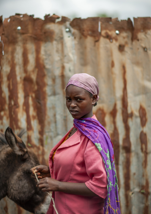 Portrait of a woman in front of a rusty fence, Oromia, Woliso, Ethiopia