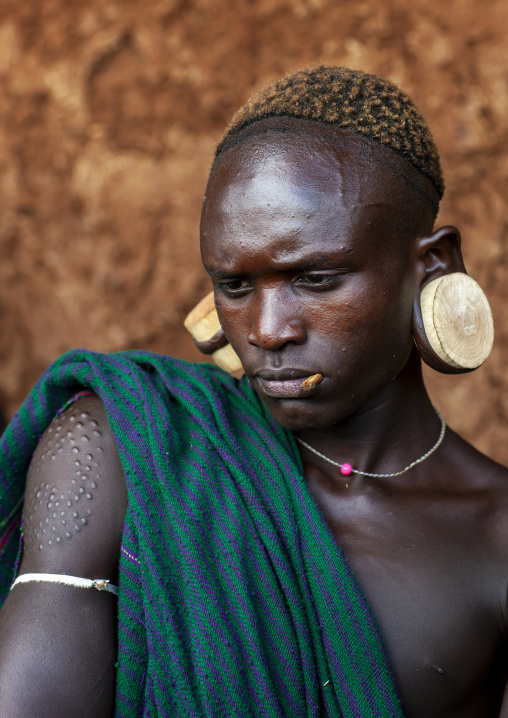 Suri tribe man with enlarged earlobes, Kibish, Omo valley, Ethiopia