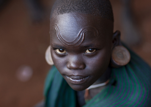 Suri tribe girl with facial scarifications, Kibish, Omo valley, Ethiopia