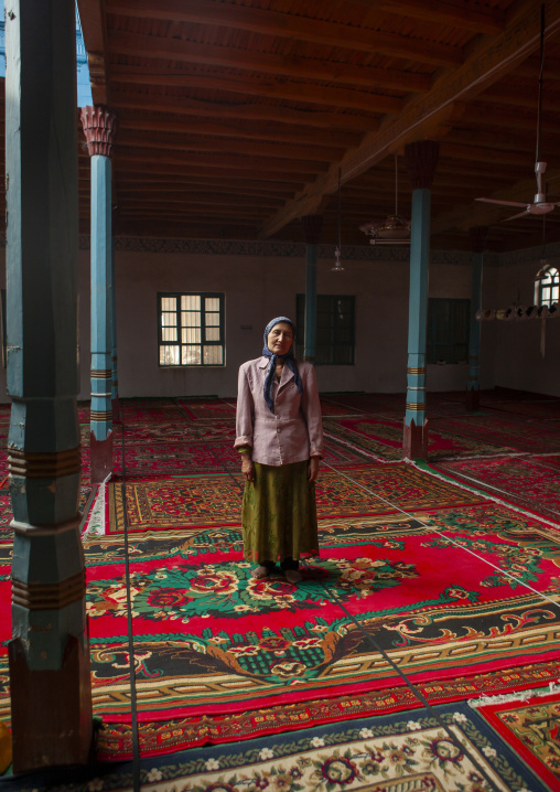 Uyghur woman standing in a mosque, Minfeng, Xinjiang uyghur autonomous region, China