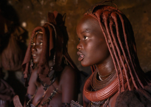 Himba women inside their hut, Kunene region, Epupa, Namibia