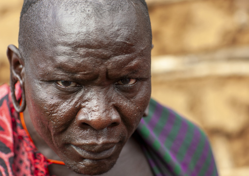 Portrait of surma tribe warrior with enlarged ears, Tulgit, Omo valley, Ethiopia