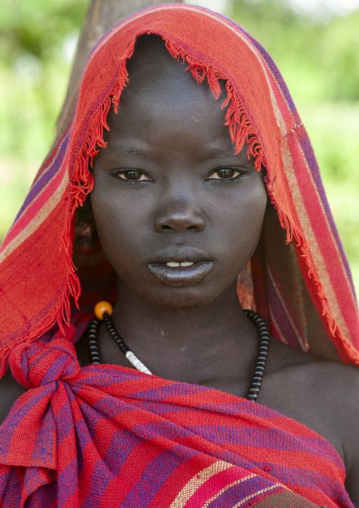 Bodi tribe teenage girl ith red veil, Omo Valley, Hana Mursi, Ethiopia