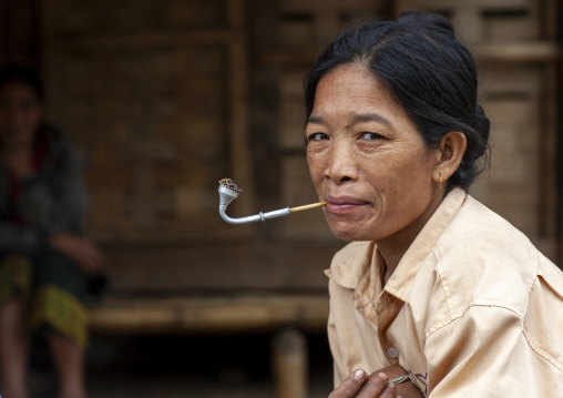 Khmu minority woman smoking pipe, Xiangkhouang province, Xieng Khouang, Laos