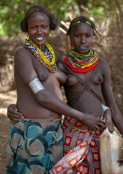 Young Dassanech tribe girls with traditional jewels and hairstyle, Omorate, Omo valley, Ethiopia