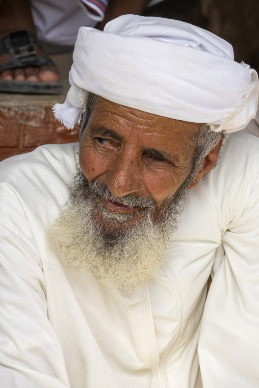 Close-up portrait of an elderly man wearing a white turban and a long grey beard, Ad Dakhiliyah Region, Nizwa, Oman