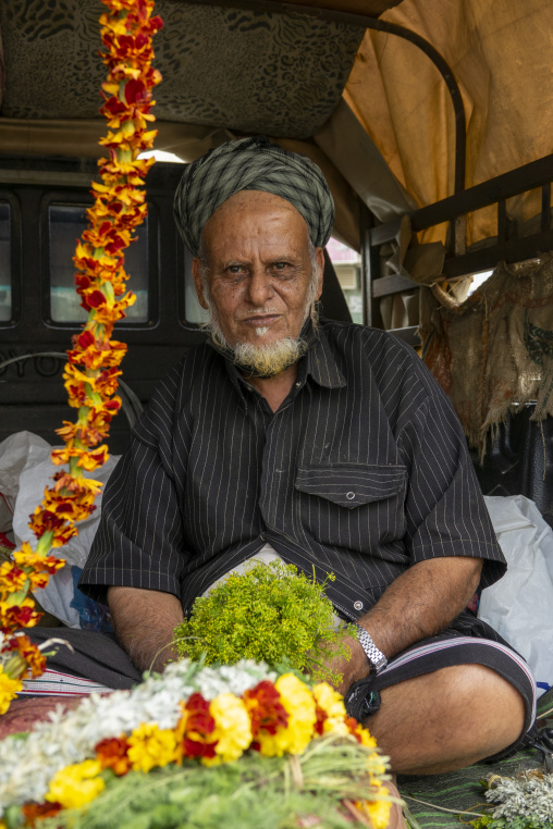 Man selling floral crowns in a market, Jazan province, Addayer, Saudi Arabia