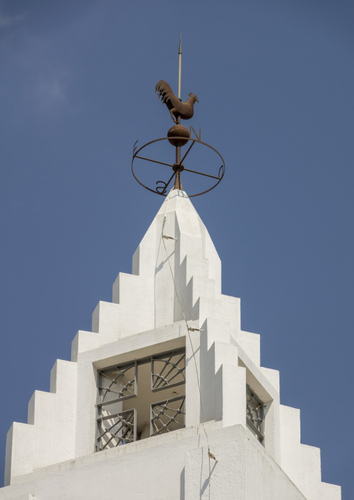 Rooster-shaped weathervane on top of a white church tower against a blue sky, Benguela Province, Benguela, Angola