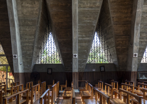 Rows of wooden pews beneath triangular concrete arches inside the Cathedral of Our Lady of Fatima, Benguela Province, Benguela, Angola