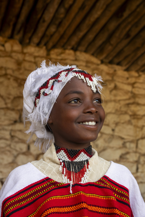 A young Sufi pilgrim wears a beaded headdress and colorful traditional dress, Oromia, Sheik Hussein, Ethiopia