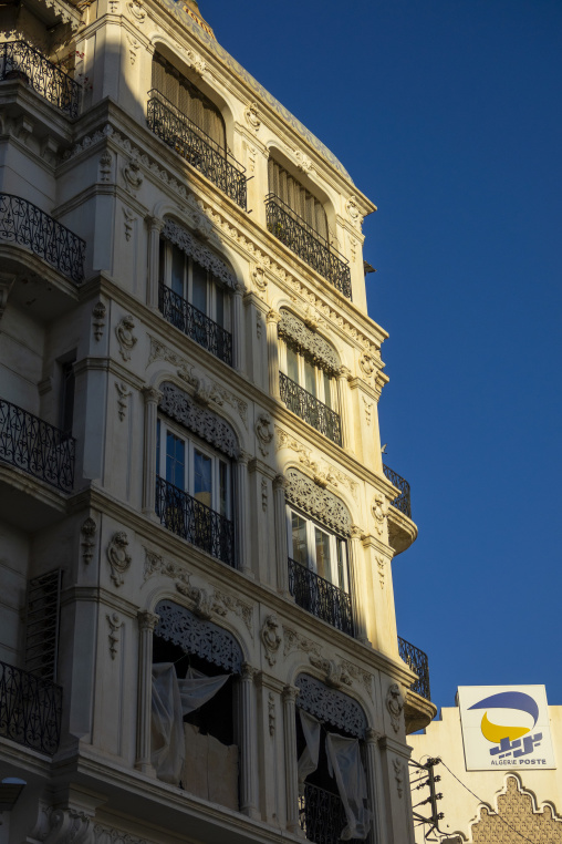 Grand French colonial building facade beside the Algérie Poste sign in the city center, North Africa, Algiers, Algeria