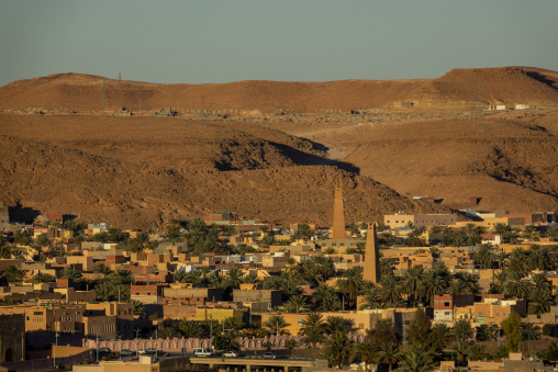 Tall minaret surrounded by palm trees, North Africa, Ghardaia, Algeria