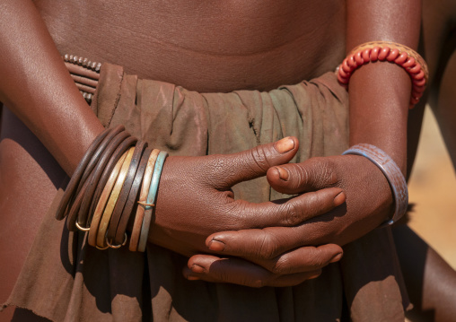 Close-up of two clasped hands adorned with colorful beaded and rubber bracelets, Cunene Province, Oncocua, Angola