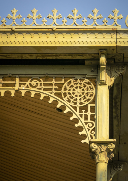 A wrought-iron finial spike rises above the fleur-de-lis cornice at the corner of the Palacio de Ferro, Luanda Province, Luanda, Angola