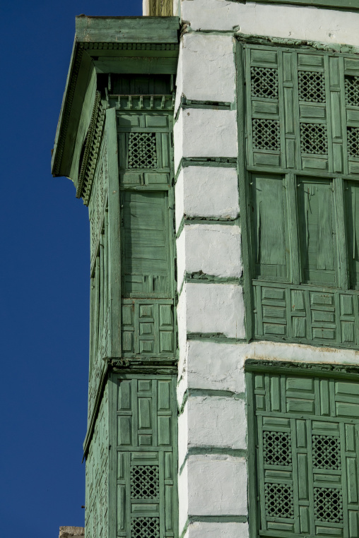 Wooden mashrabiya balconies on a historic building corner, Mecca