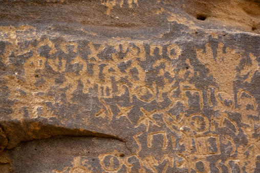 Thamudic inscriptions and symbols engraved on a sandstone rock f