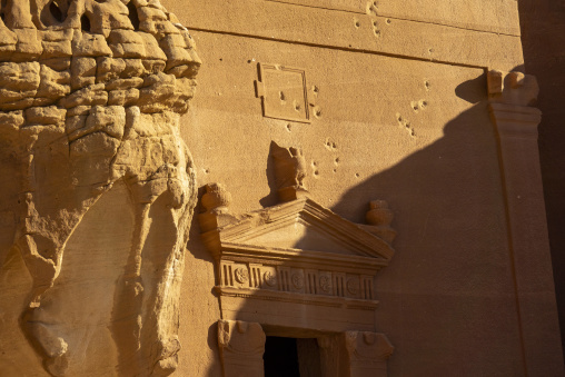 Detail of a Nabataean tomb facade carved into a sandstone cliff