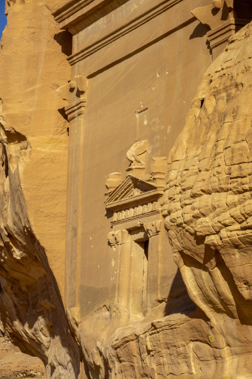 Nabataean tomb facade carved into a sandstone cliff at Hegra, Al
