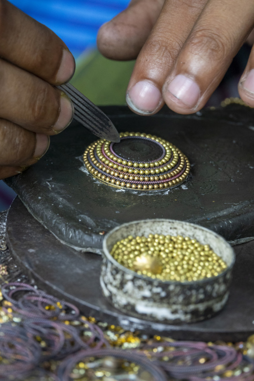 Metal worker using old lost wax casting method to create jewels, Dhaka Division, Dhamrai, Bangladesh