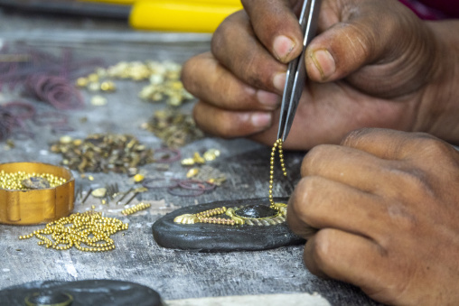 Metal worker using old lost wax casting method to create jewels, Dhaka Division, Dhamrai, Bangladesh