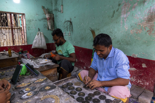 Metal worker using old lost wax casting method to create jewels, Dhaka Division, Dhamrai, Bangladesh