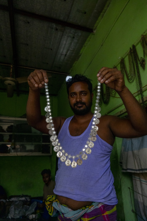 Metal worker using old lost wax casting method to create jewels, Dhaka Division, Dhamrai, Bangladesh