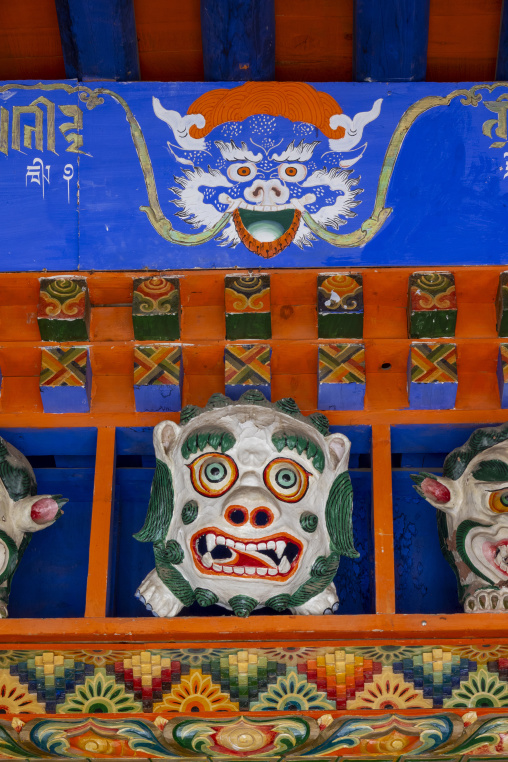 A carved dragon and lion motif adorn a painted beam at Bongya monastery, Qinghai Province, Mosele, China