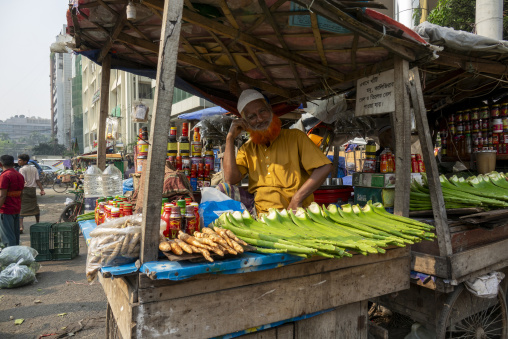 Street vendor selling banana stem and herbal products from his c