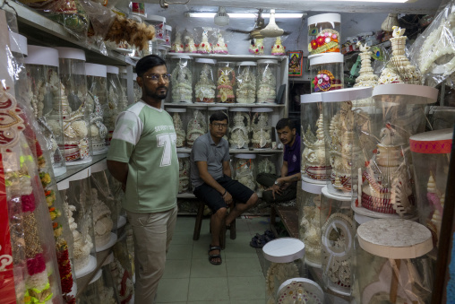 Three shopkeepers surrounded by handmade bridal crowns in a Shak