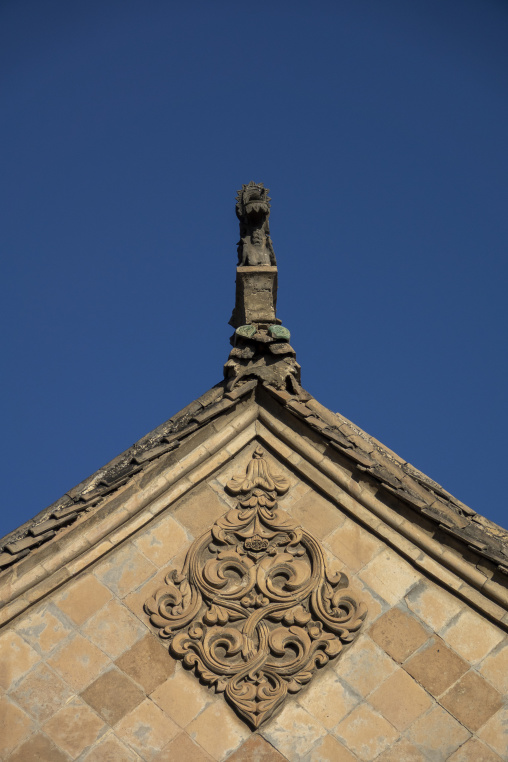 Ornate rooftop peak rises above Dong Gong Guan mansion, Gansu Province, Linxia, China
