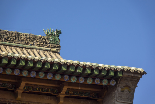 Dragon ornament decorates a roof corner at Dong Gong Guan mansion, Gansu Province, Linxia, China