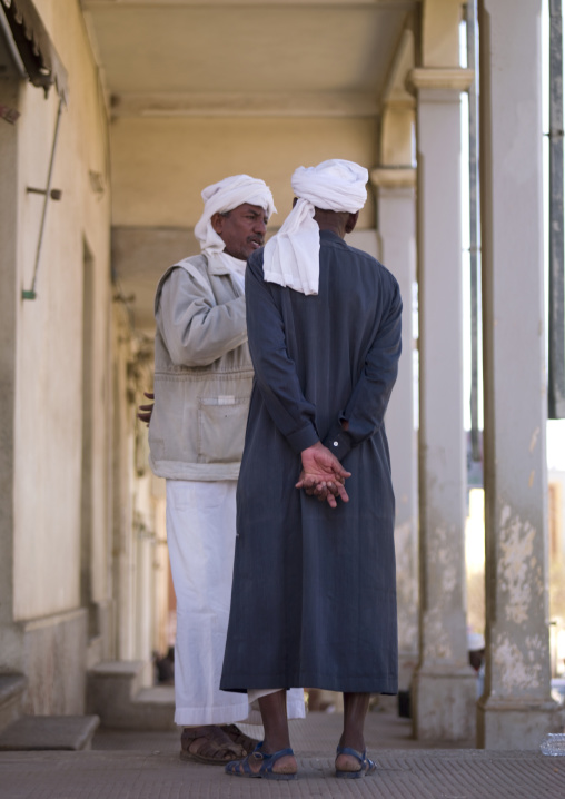 Eritrean muslim men chatting under the arcades, Central Region, Asmara, Eritrea