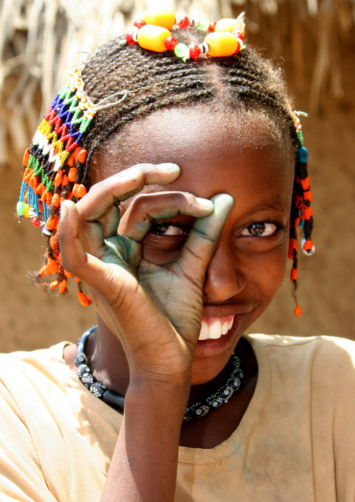 Kunama tribe girl with dreadlocks miming the photographer, Gash-Barka Region, Barentu, Eritrea