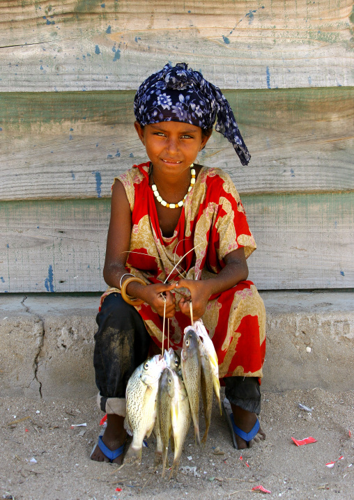 Afar girl with fresh fishes, Northern Red Sea, Thio, Eritrea