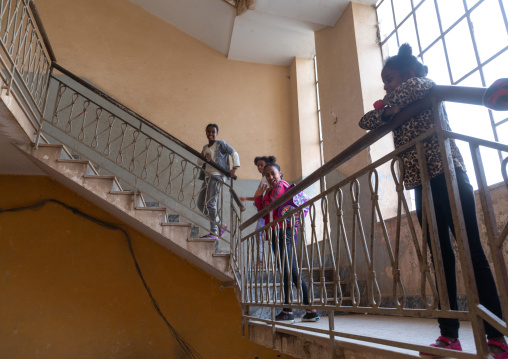 Eritrean girls in an old art deco style stairs from the italian colonial times, Central region, Asmara, Eritrea