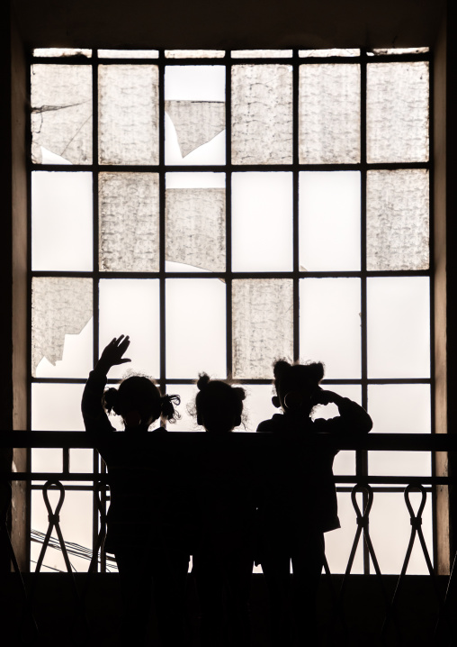 Silhouettes of children standing in front of a huge window, Central region, Asmara, Eritrea