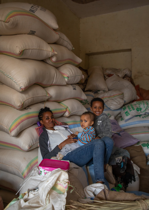 Eritrean mother with her children in a warehouse, Central region, Asmara, Eritrea