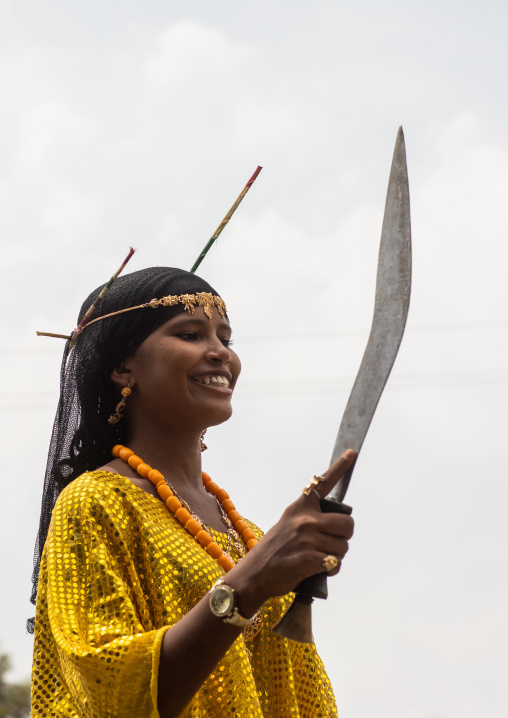 Afar tribe woman dancing with a jile knife during expo festival, Central region, Asmara, Eritrea