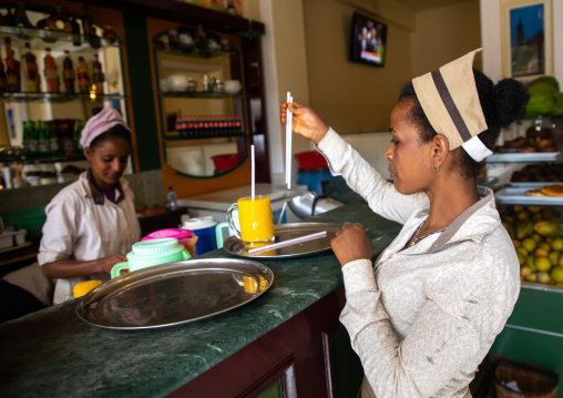 Waitresses in a bar preparing a mango juice, Central region, Asmara, Eritrea
