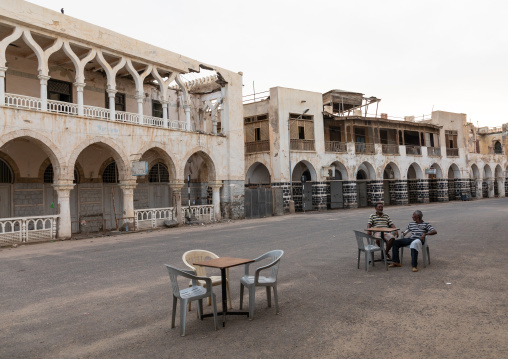 Eritrean men having a drink in front of ottoman architecture buildings, Northern Red Sea, Massawa, Eritrea