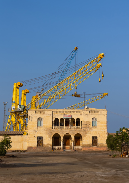Cranes in the port in front of an old colonial building, Northern Red Sea, Massawa, Eritrea