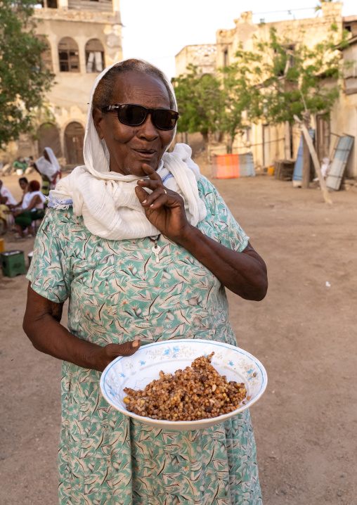 Eritrean woman offering food in the street, Northern Red Sea, Massawa, Eritrea
