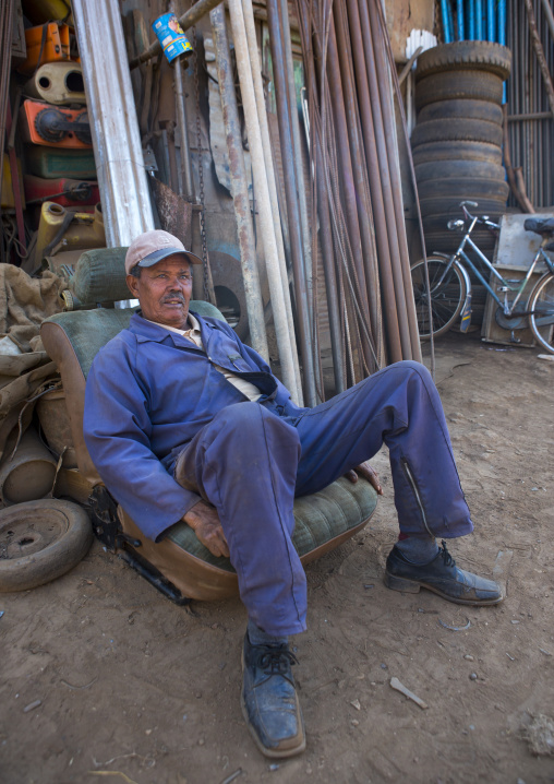 Worker resting at medebar metal market, Central Region, Asmara, Eritrea