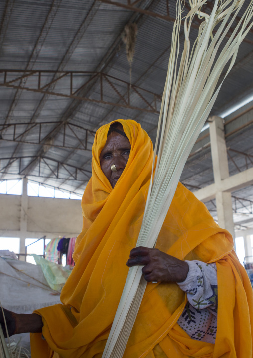 Eritrean woman with yellow traditional clothing in the market, Debub, Adi Keyh, Eritrea