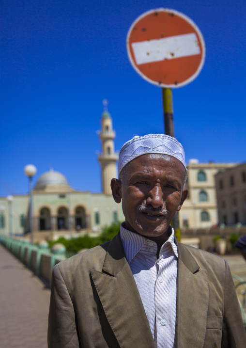 Muslim eritrean man standing in front of grand mosque kulafa al rashidin, Central Region, Asmara, Eritrea